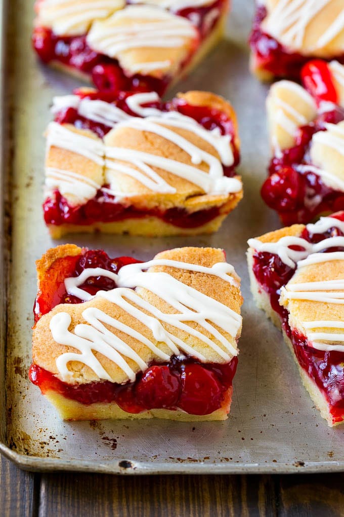 Cherry bars made with almond cookie dough on a sheet pan.