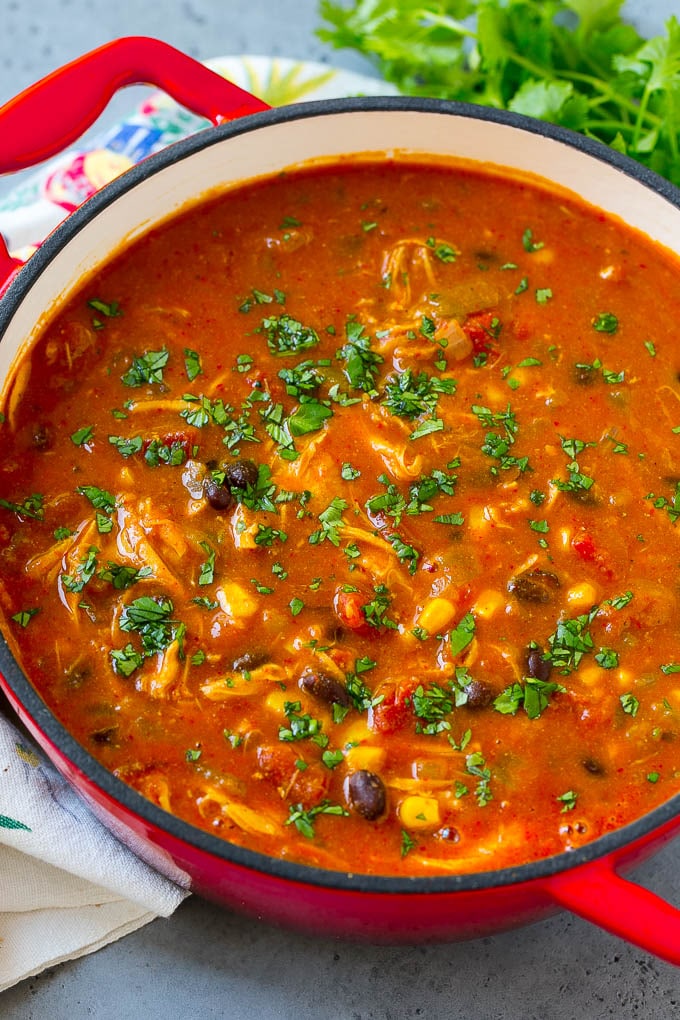 A pot of chicken enchilada soup filled with beans, tomatoes and corn.