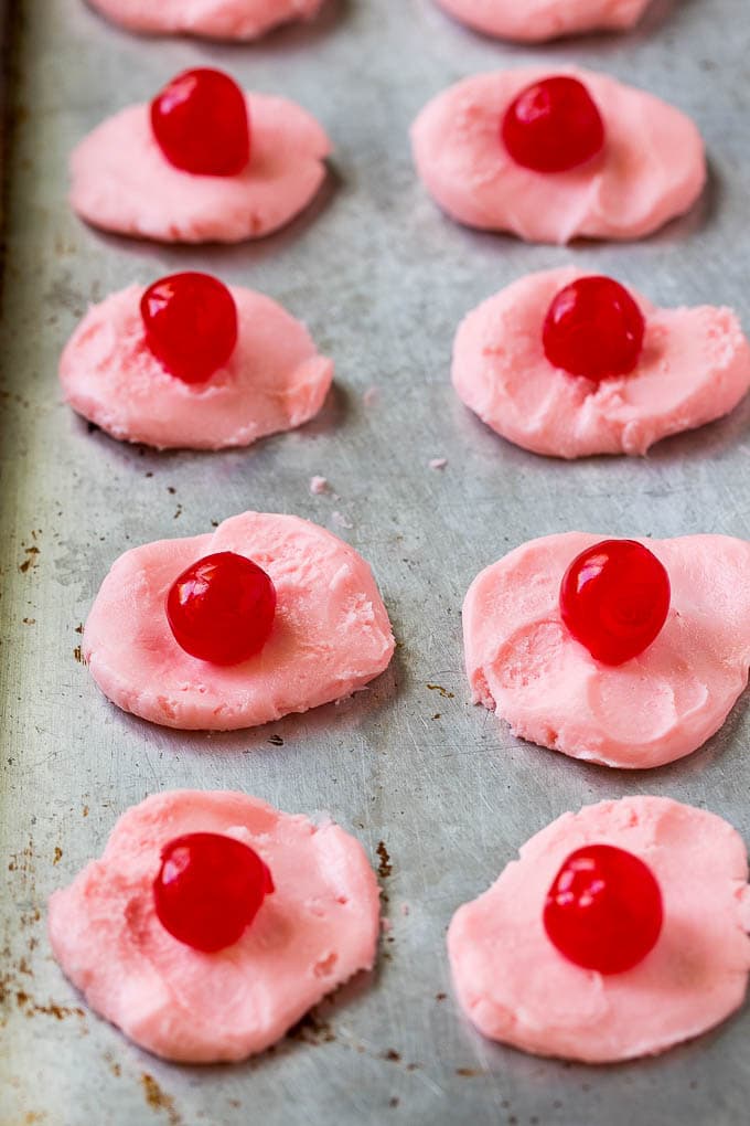 Discs of chocolate covered cherry filling with a maraschino cherry on top.