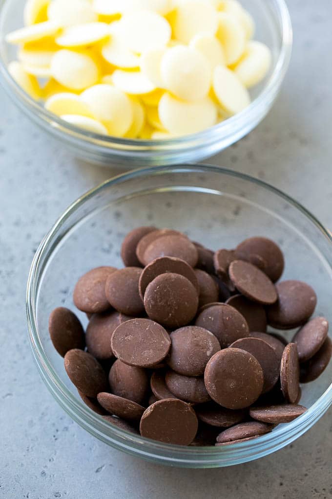Dark chocolate candy melts and white chocolate candy melts in bowls.
