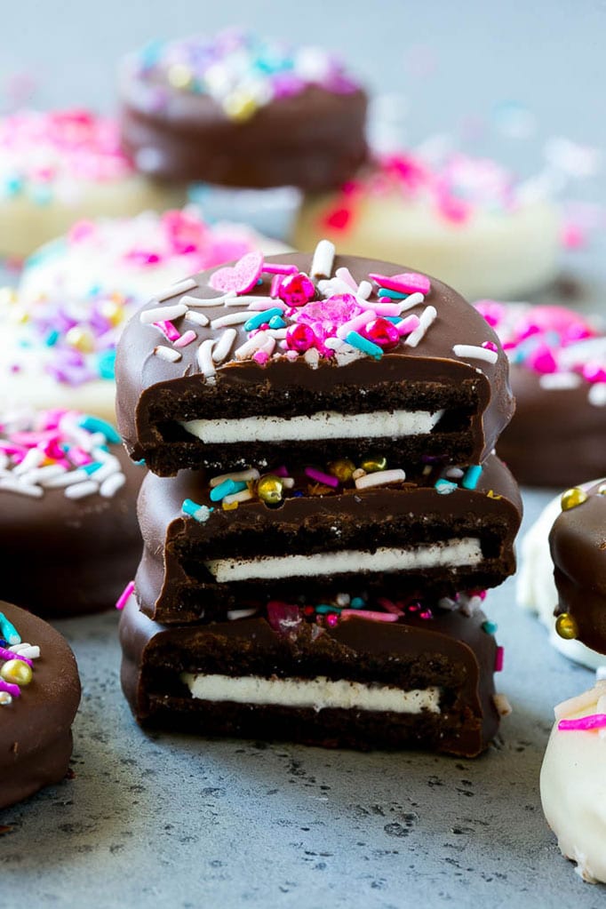 Three chocolate covered Oreos stacked on top of each other.