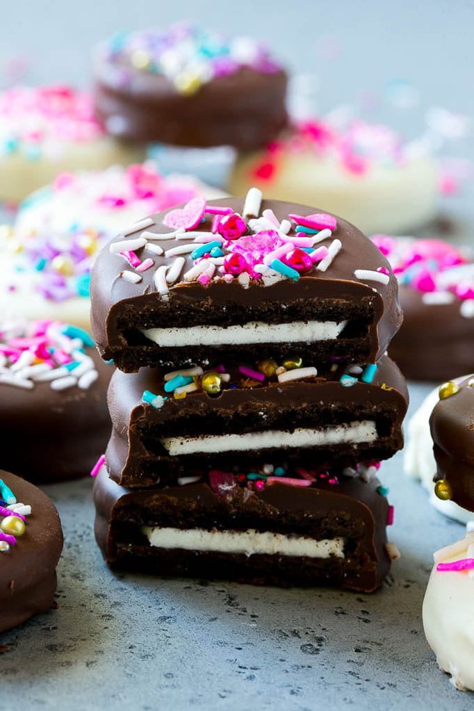 Chocolate Covered Oreos Recipe | Oreo Cookies | Chocolate Dipped Oreos #oreo #cookies #chocolate #sprinkles #dessert #dinneratthezoo Three chocolate covered Oreos stacked on top of each other.