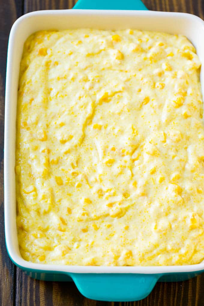 Corn pudding batter spread into a baking dish.