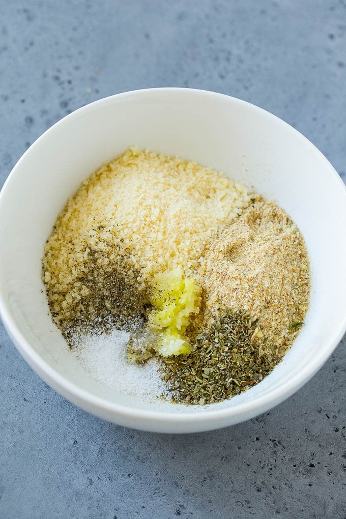A mixture of breadcrumbs, parmesan cheese, garlic and herbs in a bowl.