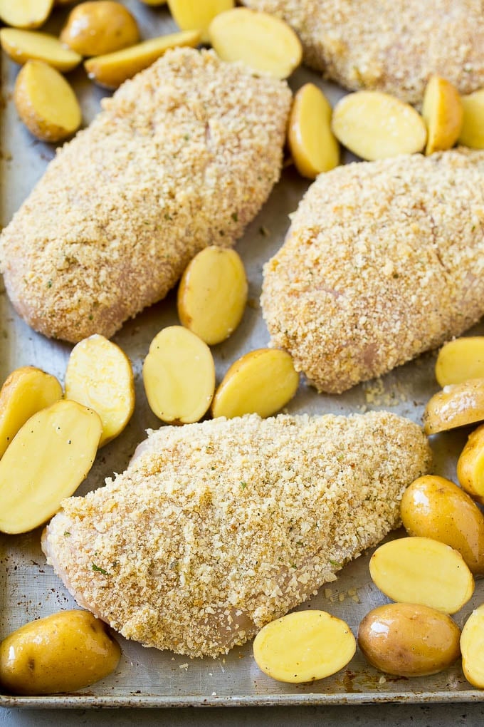 Breaded Italian chicken and potatoes on a sheet pan.
