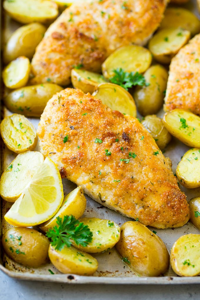 Italian chicken with a parmesan crust, along with roasted potatoes and parsley.