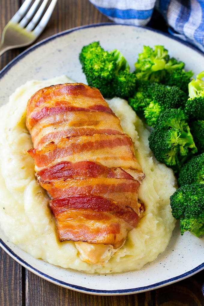 Bacon wrapped jalapeno popper chicken served with mashed potatoes and broccoli.