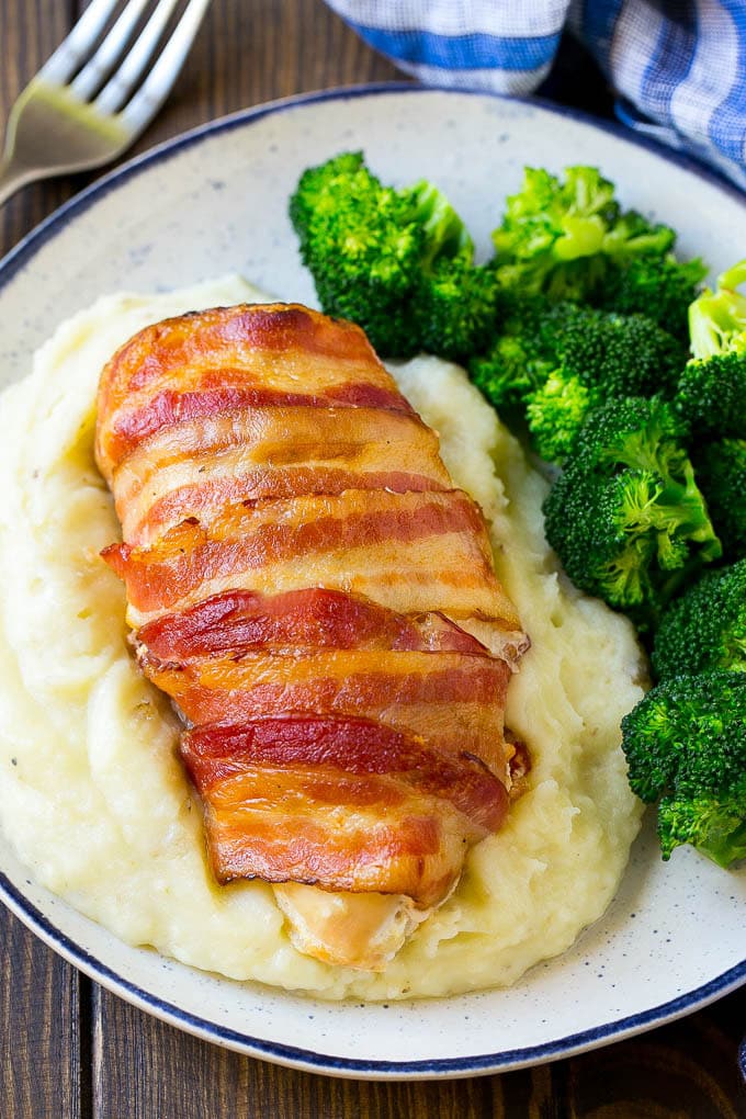 Bacon wrapped jalapeno popper chicken served with mashed potatoes and broccoli.