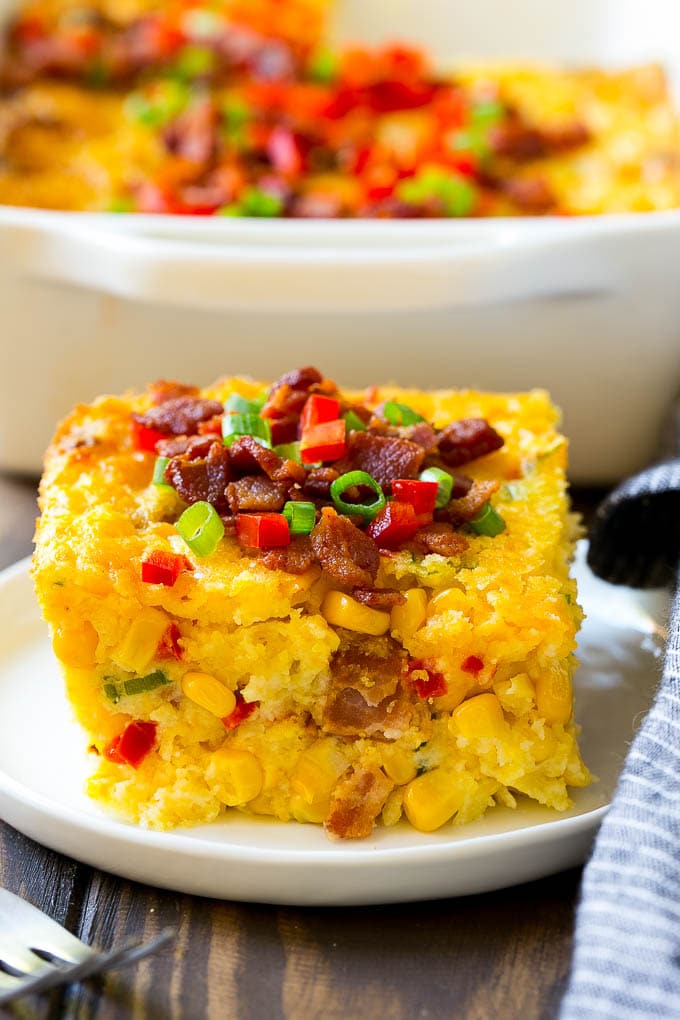 A serving of corn casserole filled with bacon, cheese and peppers.