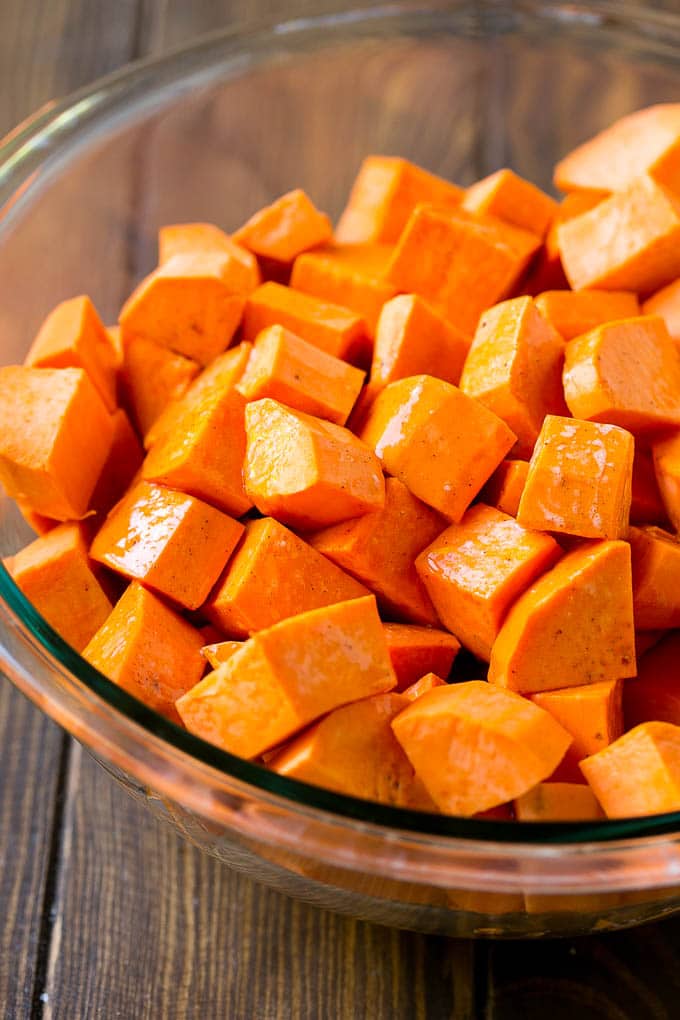 A bowl of peeled and diced sweet potatoes.