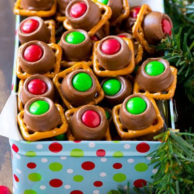 A gift tin full of Christmas colored Rolo pretzels.