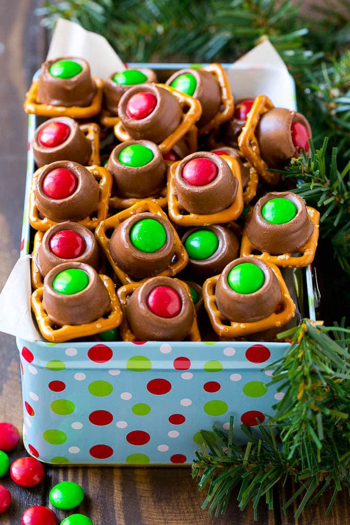 A gift tin full of Christmas colored Rolo pretzels.