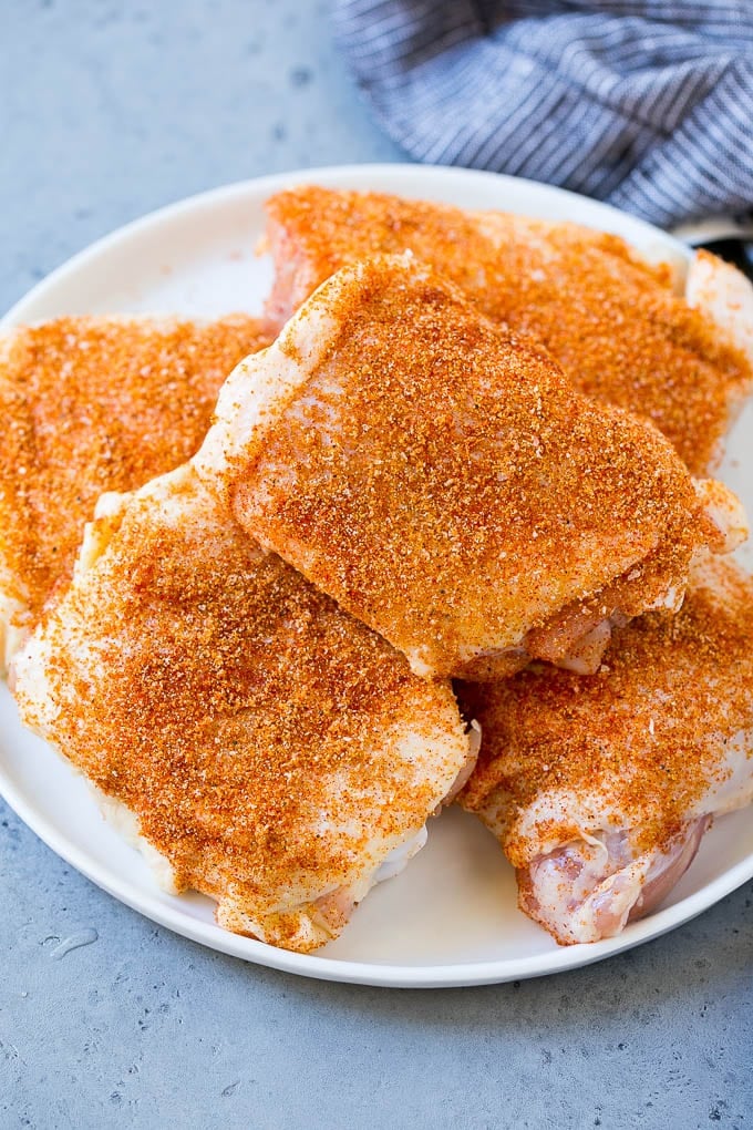 Chicken thighs coated in spice rub.