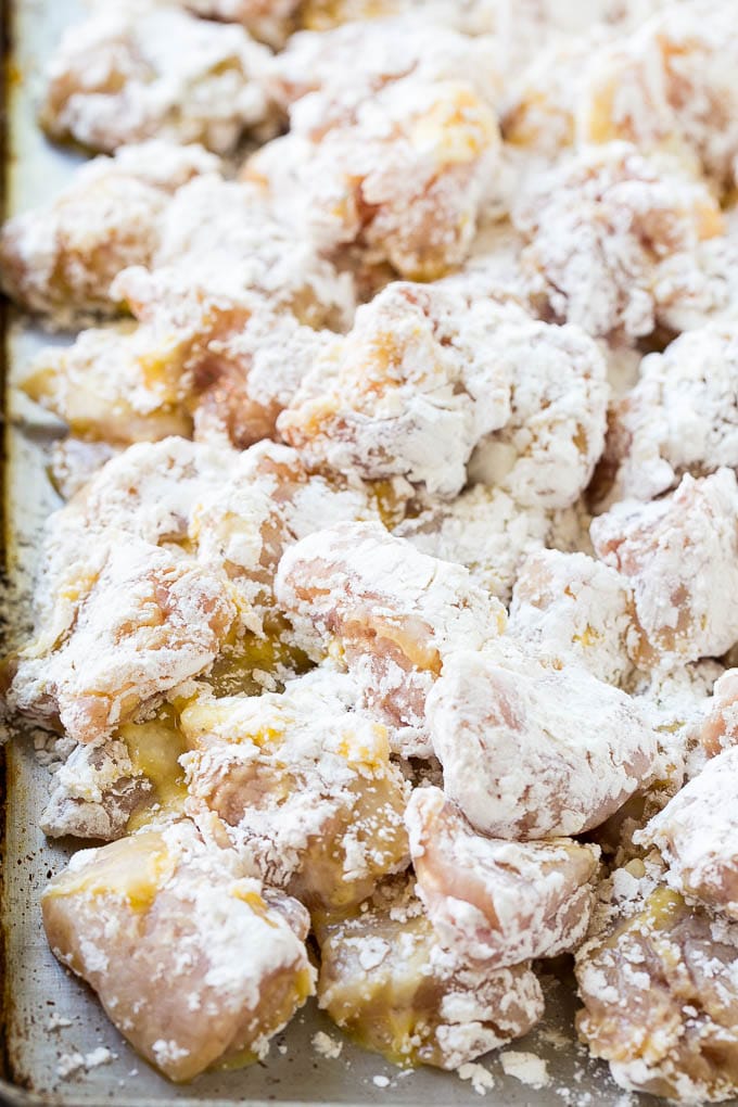 Chicken pieces coated in egg and flour.