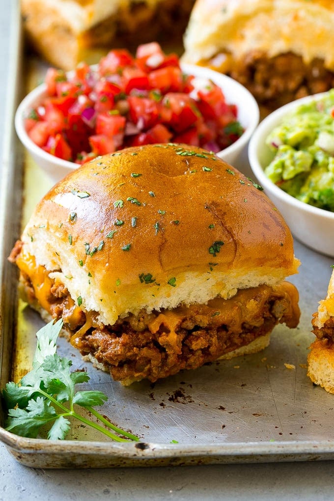 Taco sliders with salsa and guacamole on the side.
