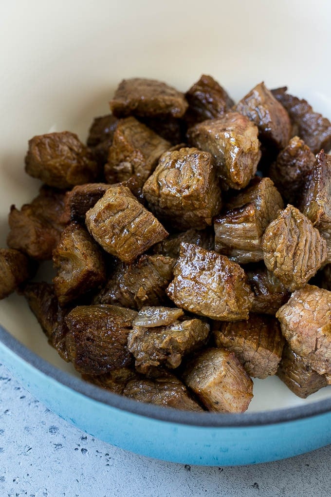 Seared beef stew meat in a soup pot.