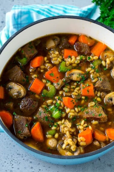 A pot full of beef barley soup made with beef stew meat, barley and vegetables all simmered together.