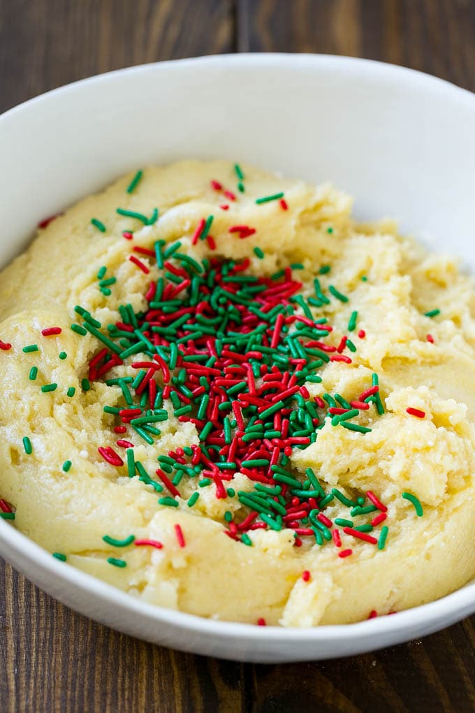 A bowl of dough with sprinkles on top.