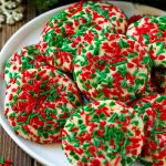 A plate of cake mix cookies rolled in colorful sprinkles.