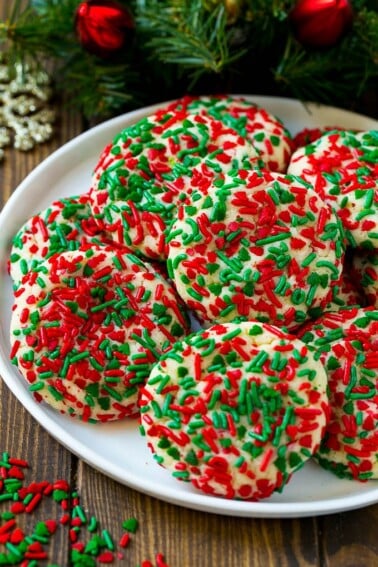 A plate of cake mix cookies rolled in colorful sprinkles.