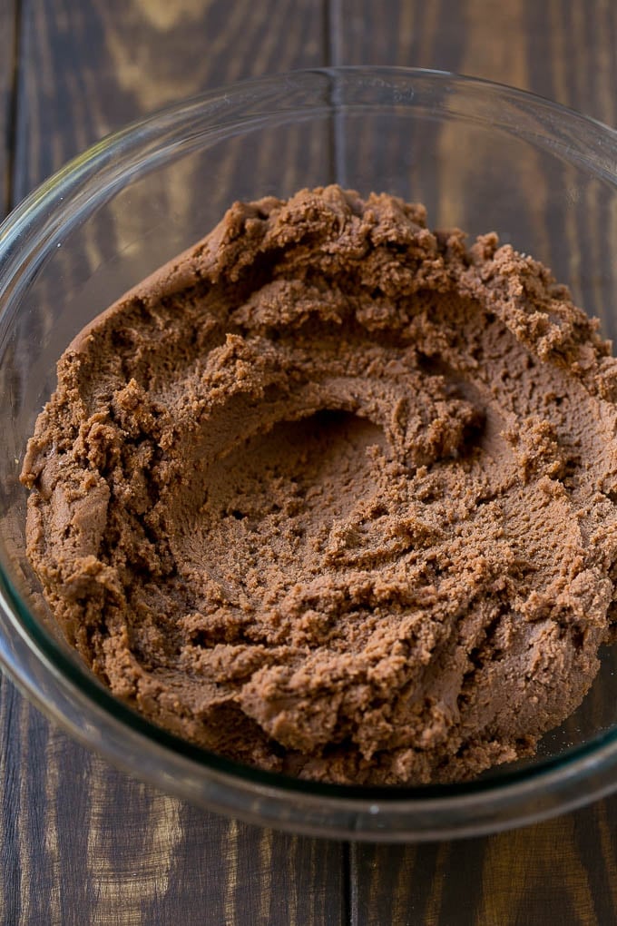 Chocolate spritz cookie dough in a mixing bowl.