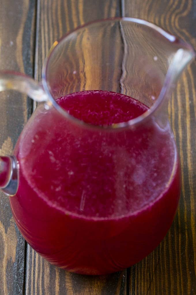 A pitcher with pomegranate-cranberry juice and limeade concentrate.