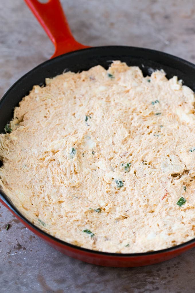 Crab dip in a skillet ready to go into the oven.