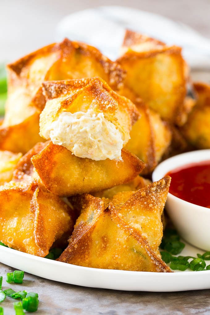 A cross section of crab rangoon with crispy wontons stuffed with cream cheese and crab.