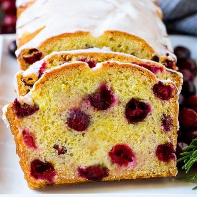 Sliced cranberry bread on a serving plate.