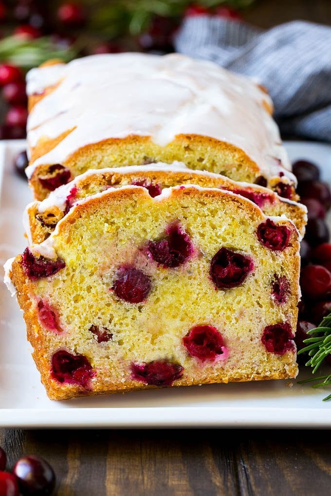 Sliced cranberry bread on a serving plate.