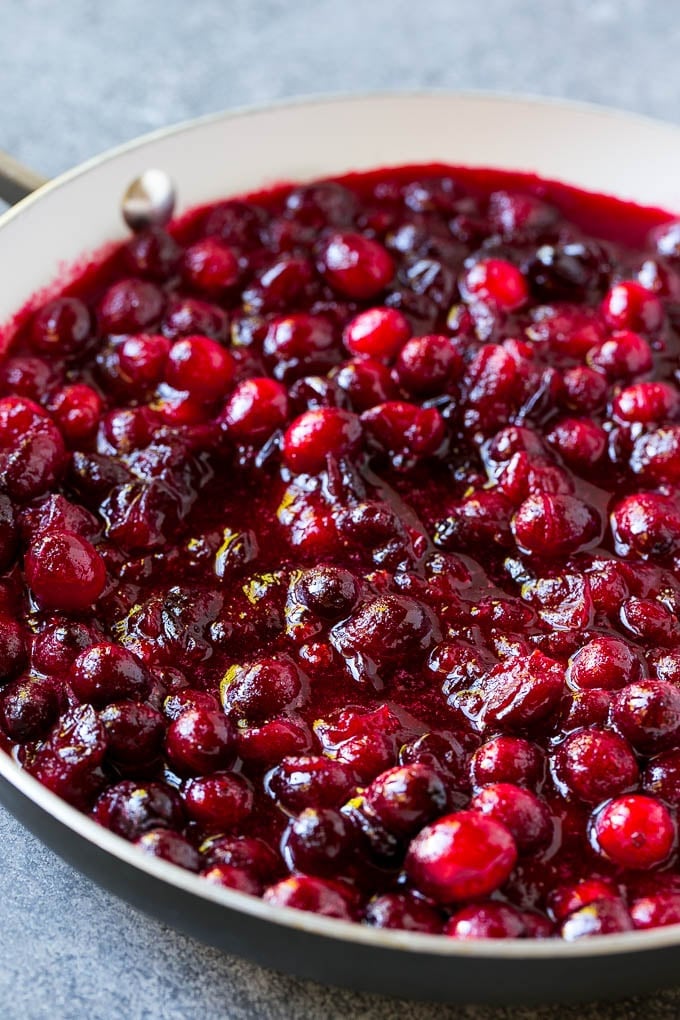 Cranberry orange sauce simmering in a skillet.