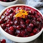 A bowl of cranberry orange sauce topped with fresh orange zest.