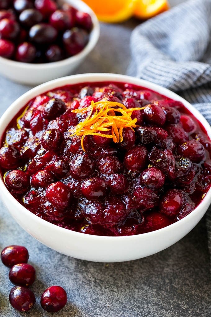 A bowl of cranberry orange sauce topped with fresh orange zest.