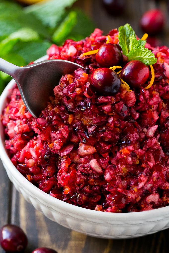 A serving spoon in a bowl of cranberry relish.
