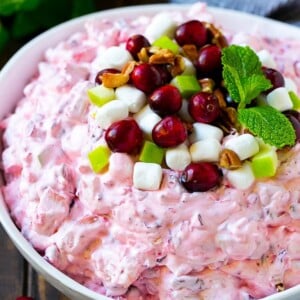 Cranberry salad garnished with cranberries, marshmallows, pecans and apples.