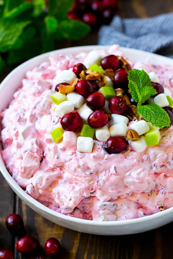 Cranberry salad garnished with cranberries, marshmallows, pecans and apples.