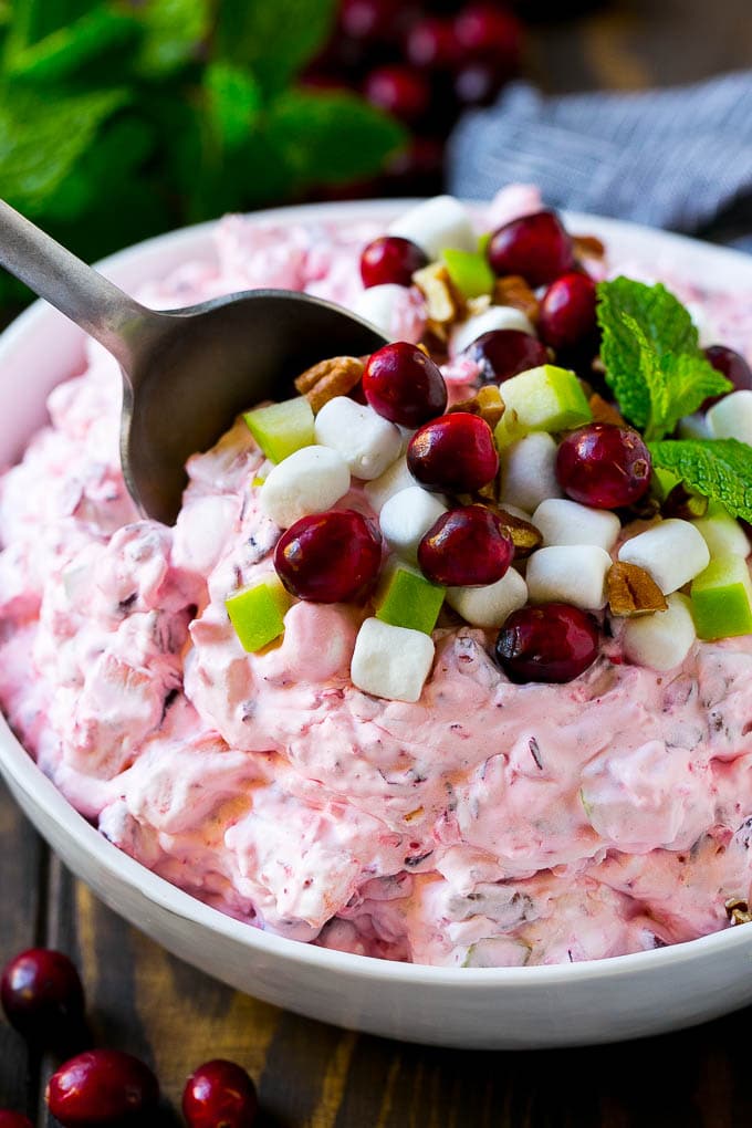 Cranberry salad with a serving spoon in it.