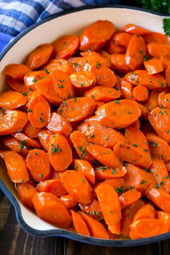 A skillet of glazed carrots with brown sugar and butter sauce.