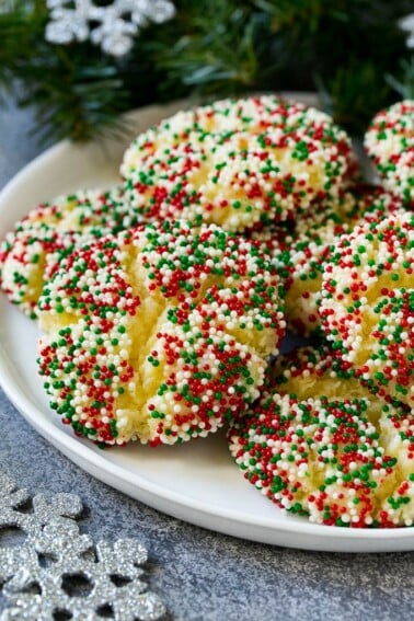 A plate of gooey butter cookies covered in holiday sprinkles.