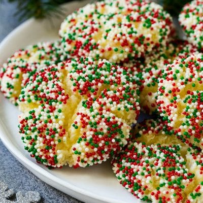 A plate of gooey butter cookies covered in holiday sprinkles.