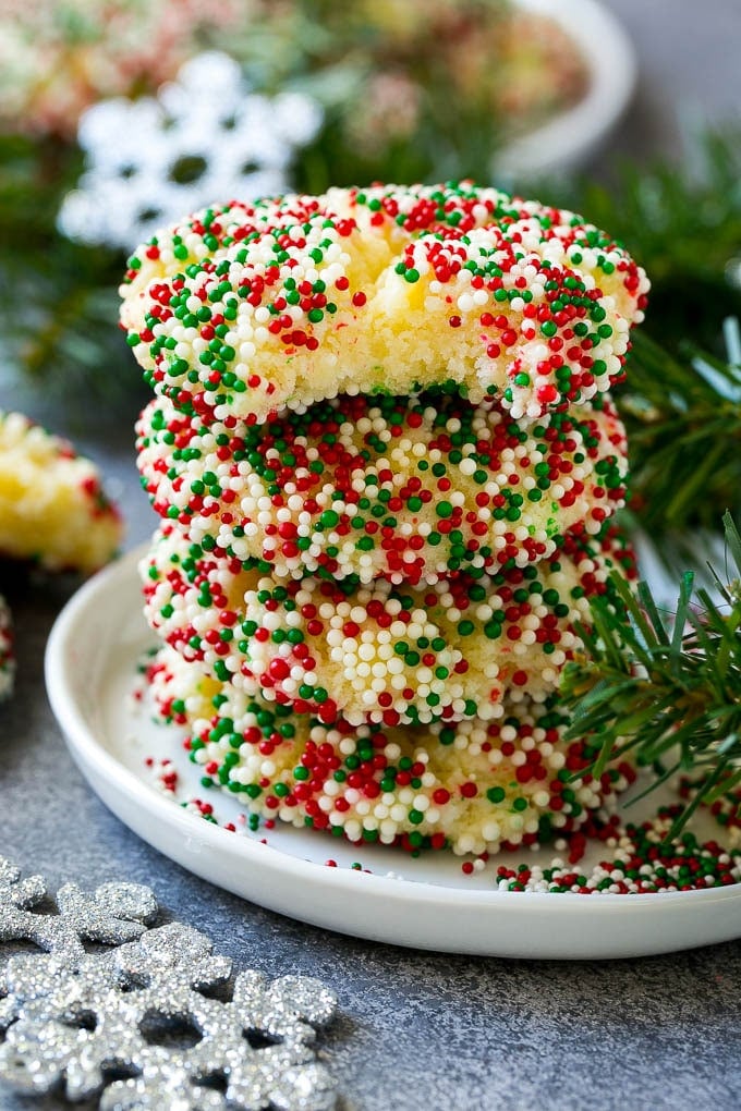 A stack of gooey butter cookies with a bite taken out of one.