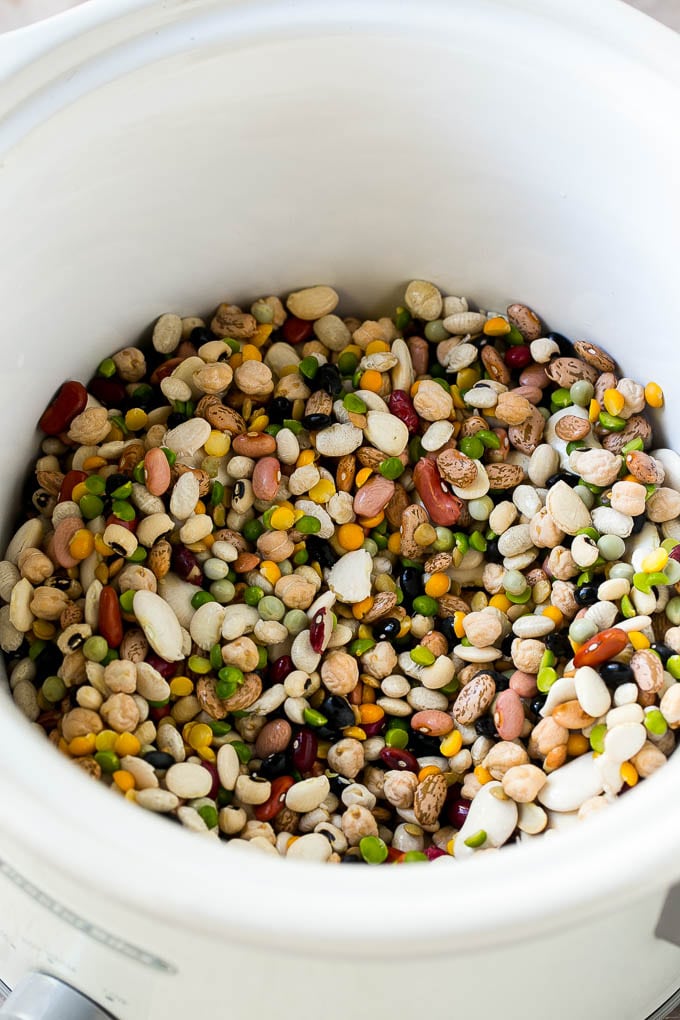 A mixture of dried beans in a crock pot.