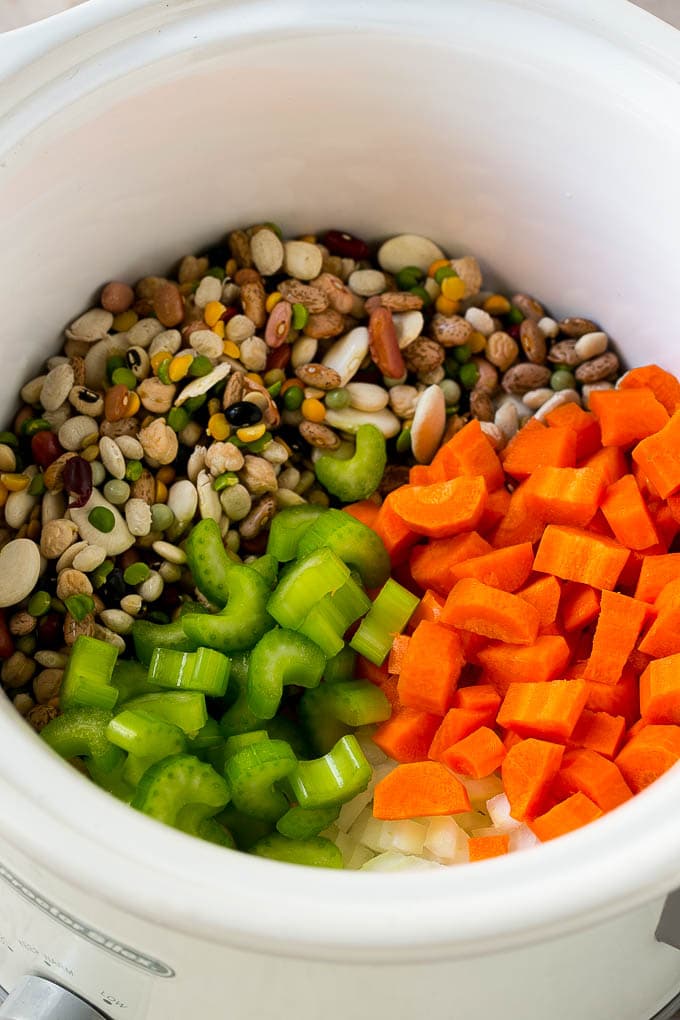 Dried beans, carrots, onions and celery in the slow cooker.