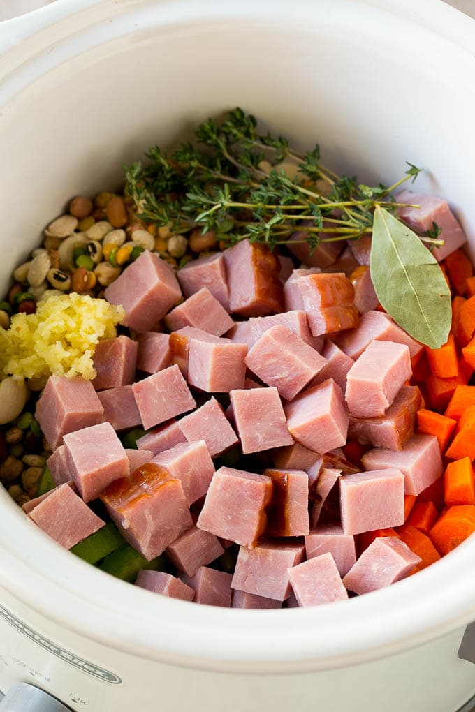 Vegetables, pork, herbs and garlic in the slow cooker.