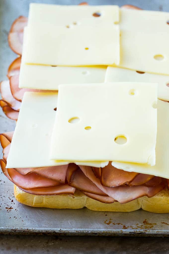 Ham and swiss cheese stacked onto Hawaiian rolls.
