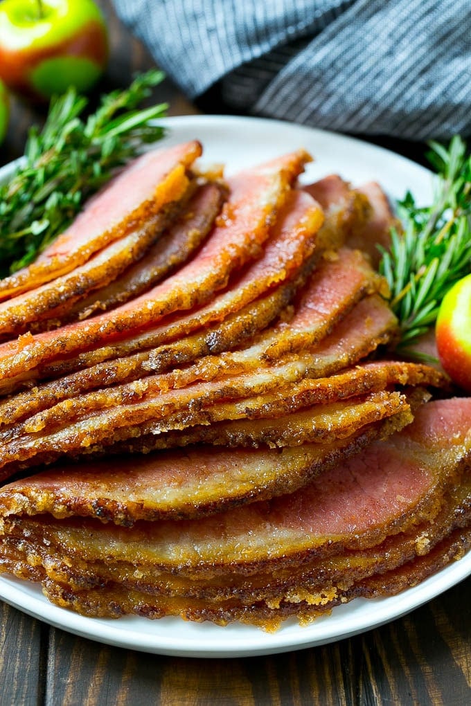 Sliced honey baked ham on a serving plate.