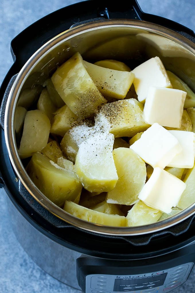 Cooked chunks of potatoes with butter, milk and seasonings in an Instant Pot.