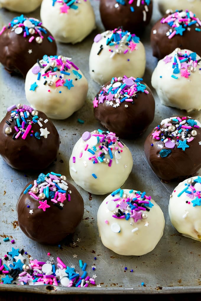 Assorted colors of Oreo balls on a sheet pan.