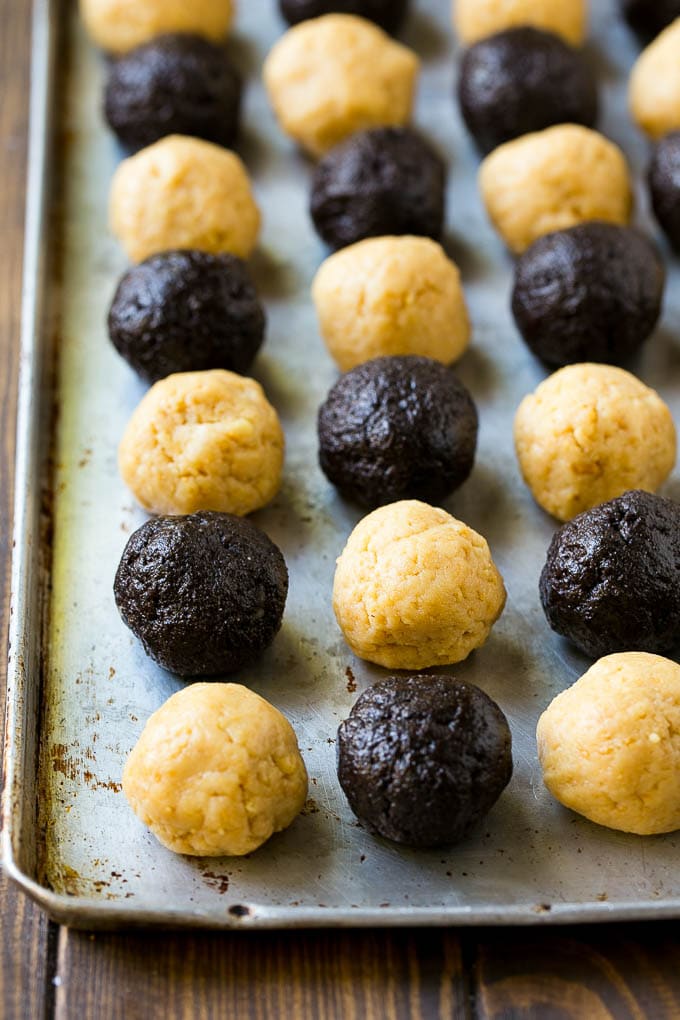 Oreo ball centers made from vanilla and chocolate Oreos on a sheet pan.
