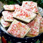 A gift tin full of peppermint bark made with crushed candy canes.